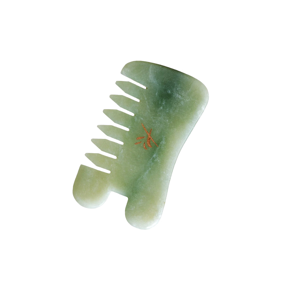 Yin Your Skin LOVI Gua Sha Comb made of green Xiuyan jade, designed with a U-shaped notch for massaging the face, scalp, and body.