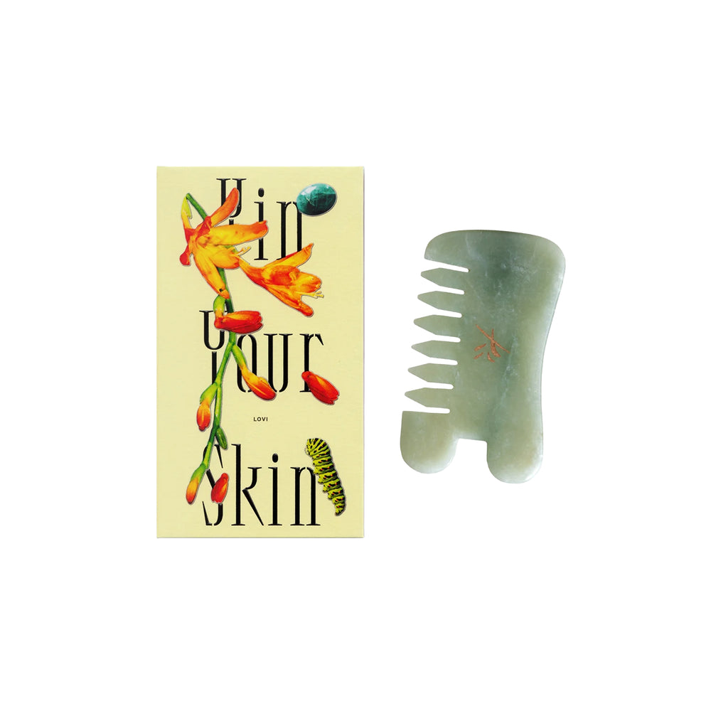 Yin Your Skin LOVI Gua Sha Comb made of green Xiuyan jade, designed with a U-shaped notch for massaging the face, scalp, and body.