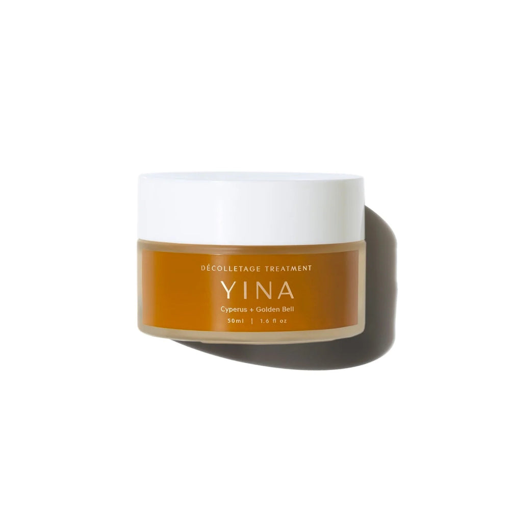 A 50ml jar of YINA Decolletage Creamon a white background with a soft shadow. The jar has a white lid and a warm amber-brown label with white text.