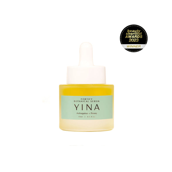 YINA Fortify Botanical Serum in clear glass matte bottle with mint colored label and white pipette on white background