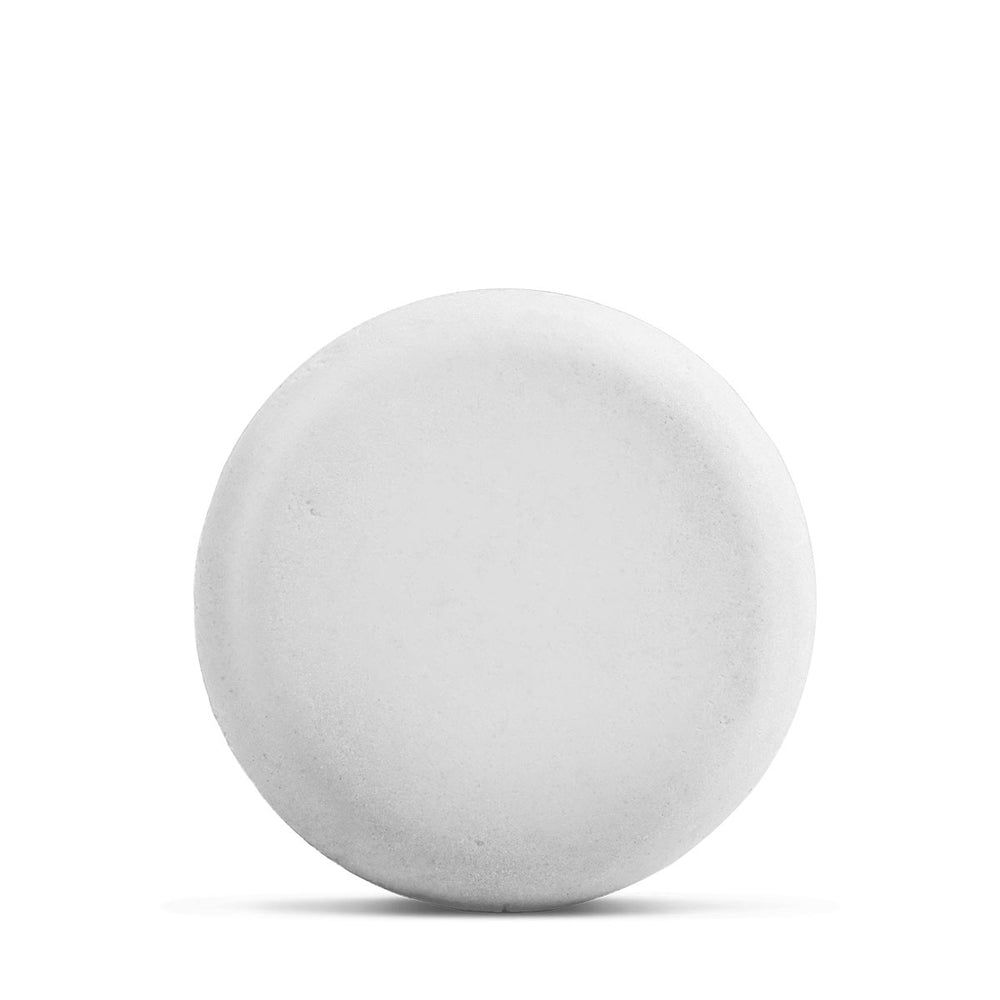 Close-up of the Ayuna SHAMPOO bar showing its solid texture on white background